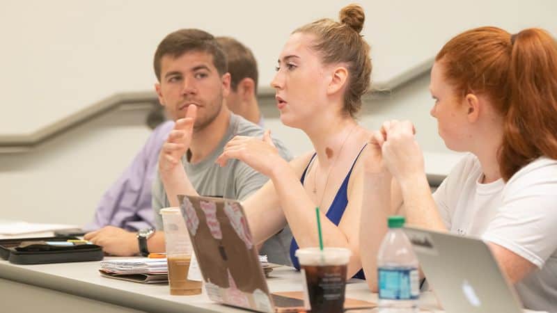 Student asking a question during class lecture at GMU Arlington class.