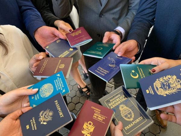 TFAS International participants fan out their passports, representing many different countries.